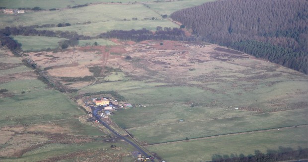 View of Eden House and the rough grazing behind it that contains the cairnfield